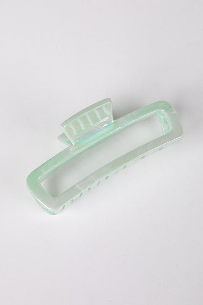Mint green hair clip on a white background