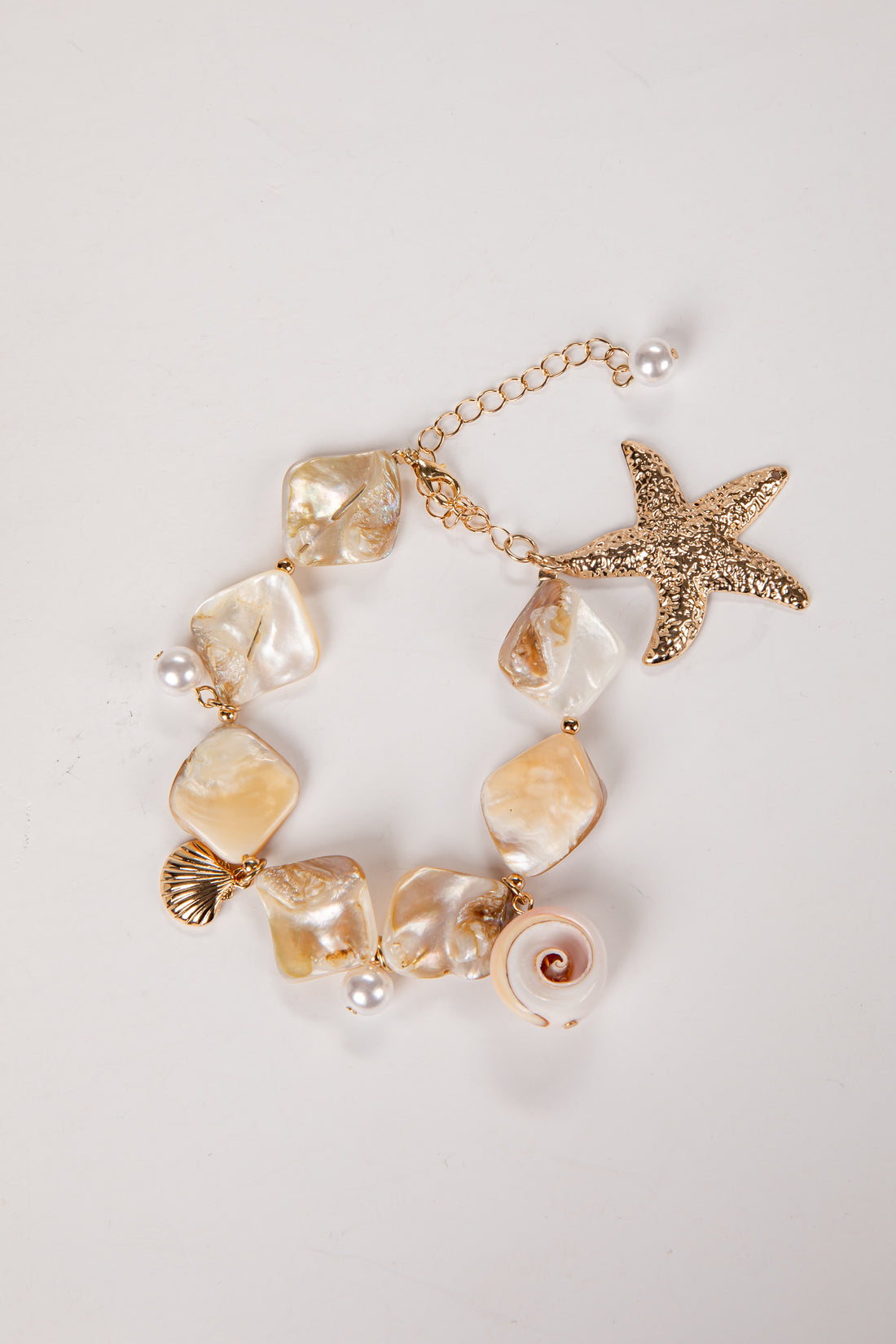 Bracelet with pearls and starfish charm on a light background