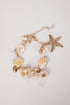 Bracelet with pearls and starfish charm on a light background