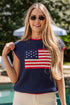 Woman wearing a navy sweater with an American flag design by a poolside.
