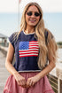Woman wearing a navy blue t-shirt with an American flag design, standing on a wooden dock.