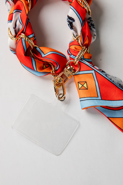Phone case with a orange and white scarf accessory on a white background