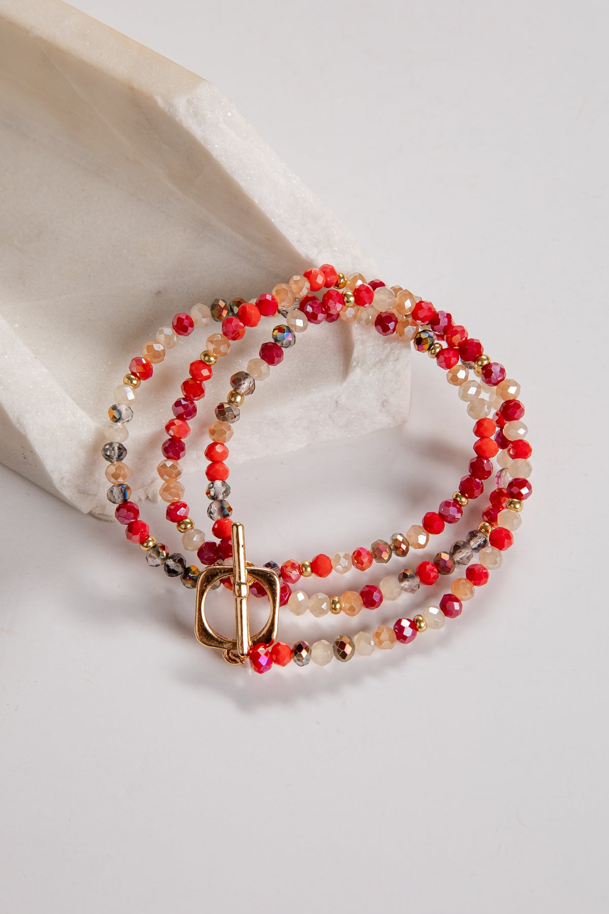 Beaded bracelet with a gold clasp on a light background