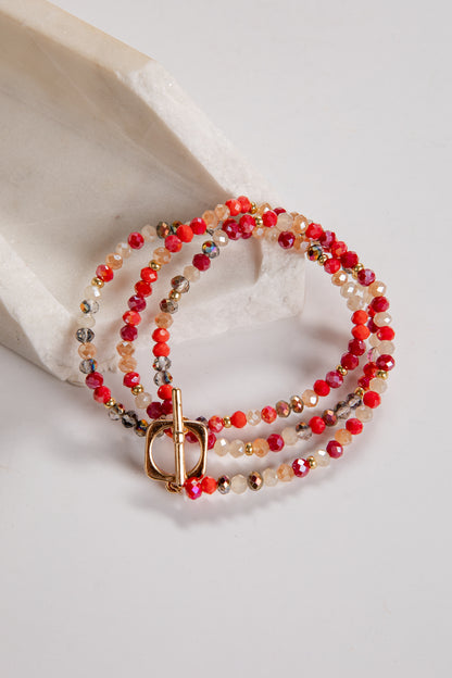 Beaded bracelet with a gold clasp on a light background