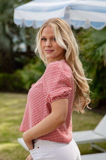 Woman wearing a red checkered shirt in an outdoor setting