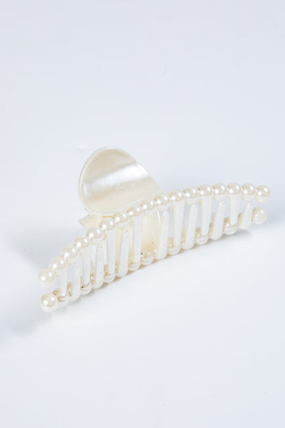 Pearl decorative hair clip on a white background