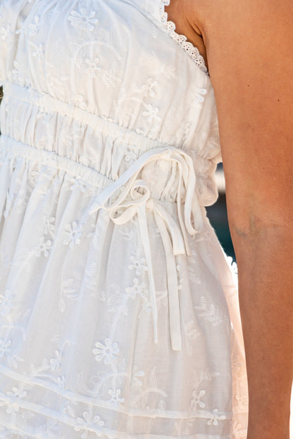 White dress with lace details on a blurred background