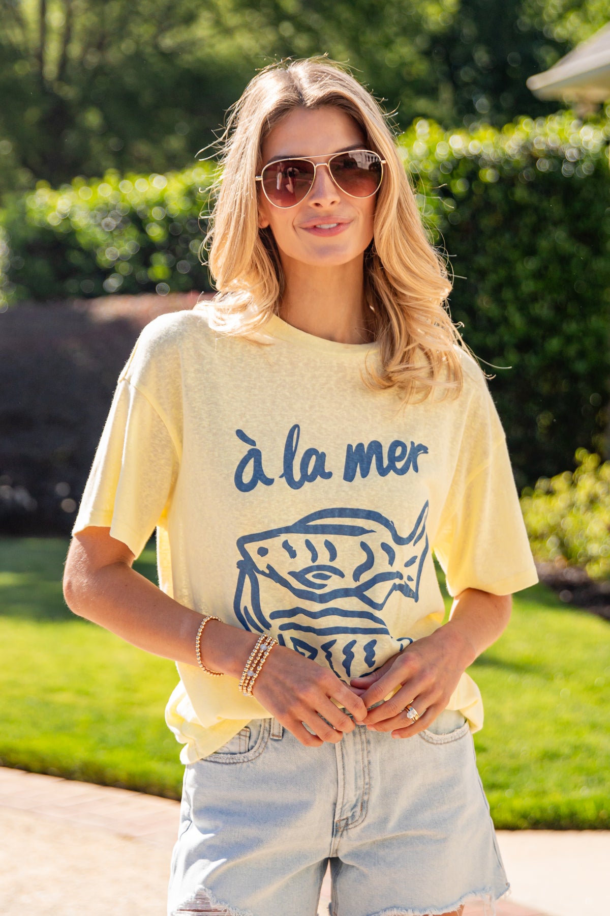 Woman wearing a yellow t-shirt with &