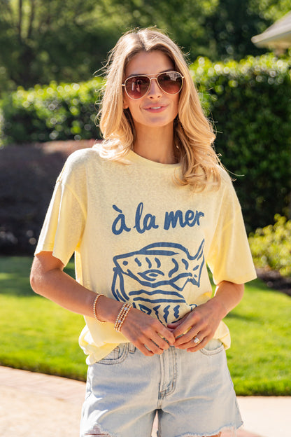 Woman wearing a yellow t-shirt with &