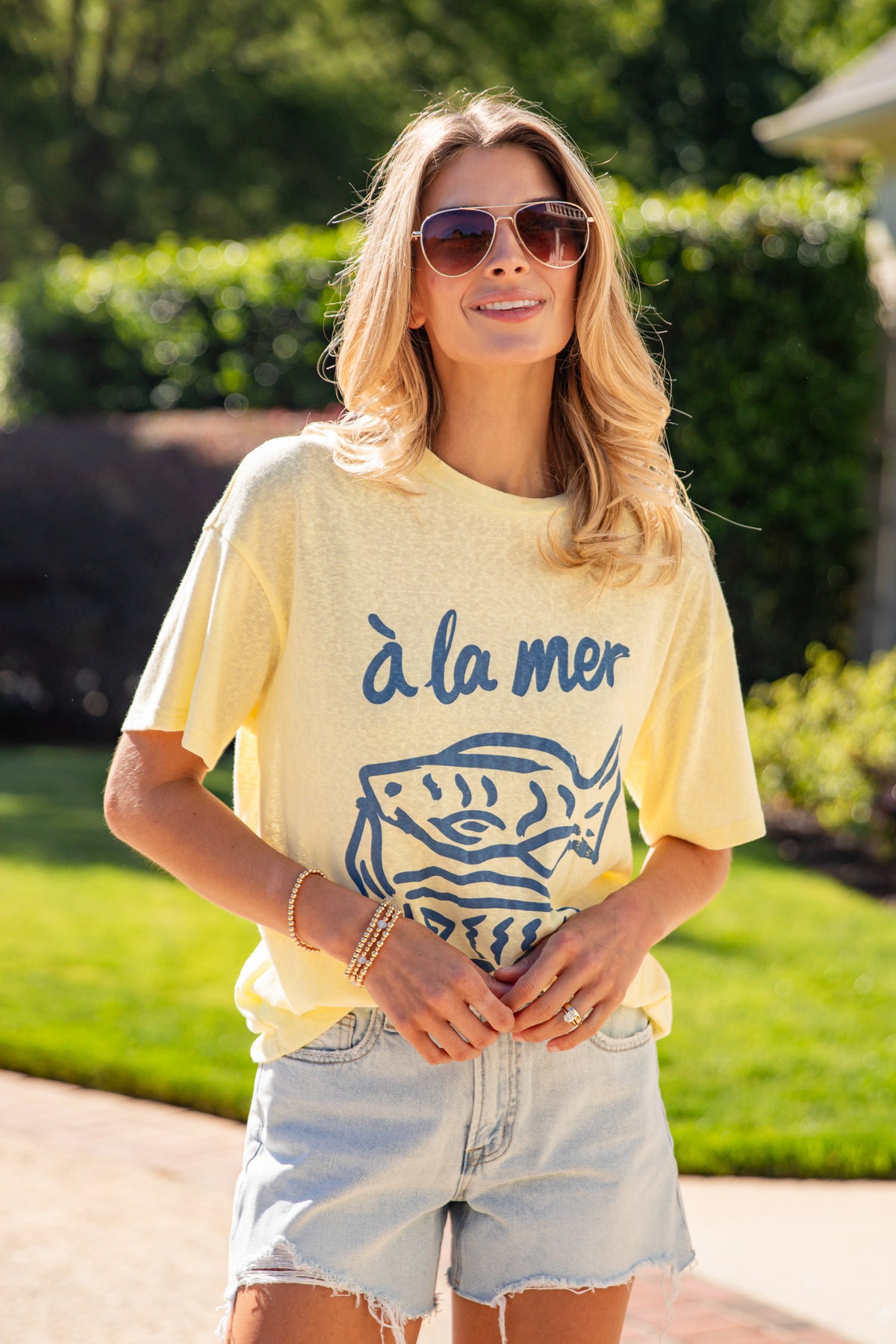 Woman wearing a yellow t-shirt with &